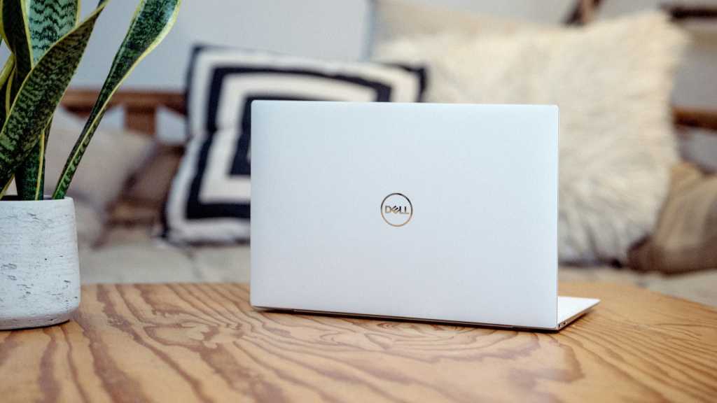 Dell laptop on wooden desk at home