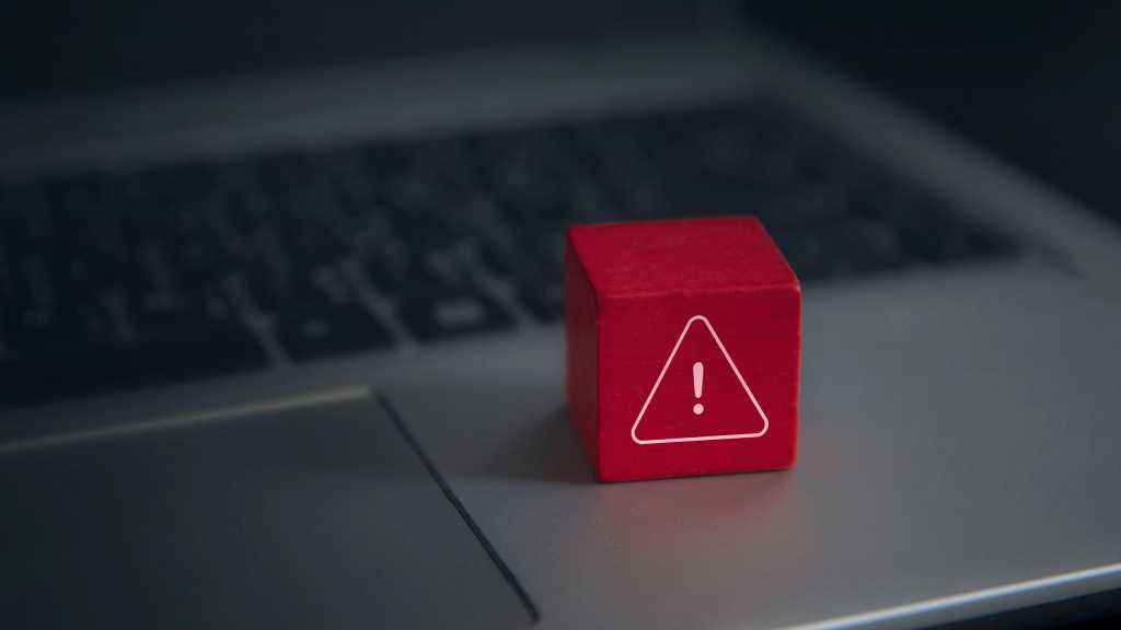 Computer error visualized as a Toy Block placed upon a Laptop keyboard