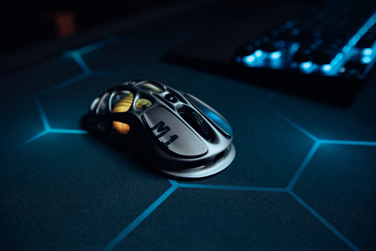 High-tech gaming mouse on illuminated hexagonal pattern mousepad, perfect for gamers.
