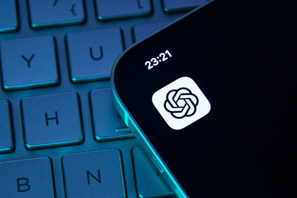 ChatGPT app icon on iPhone sitting on top of darkened keyboard