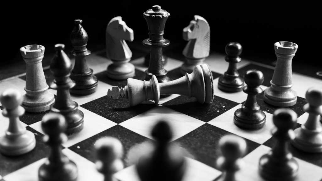 Fallen chess piece on a dramatic chess board