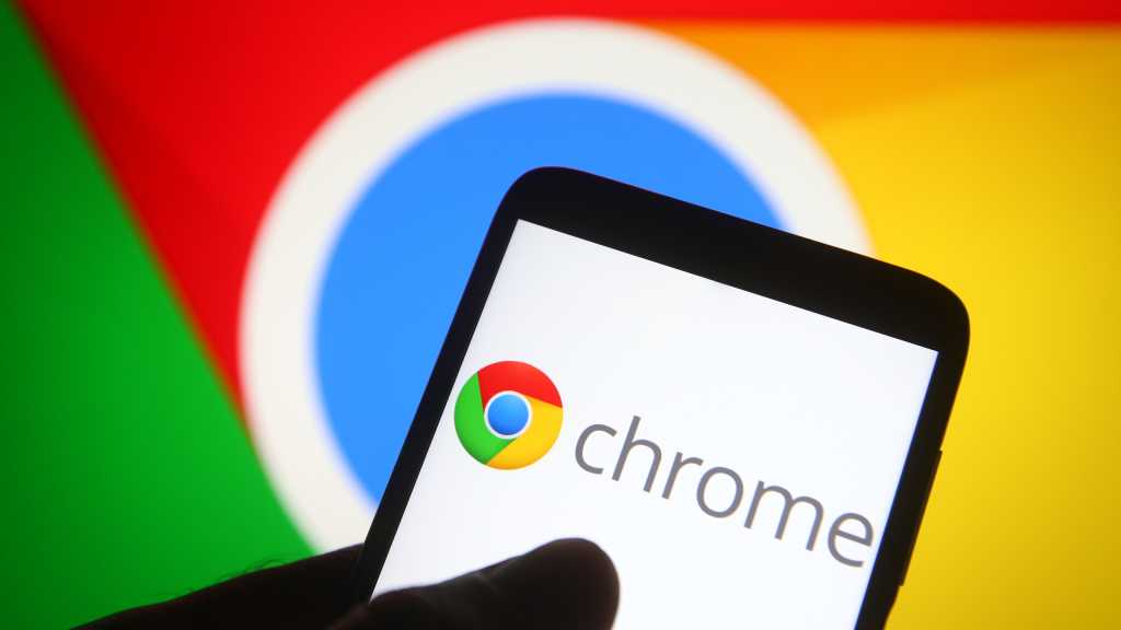 Chrome logo on phone in front of larger Chrome display in background