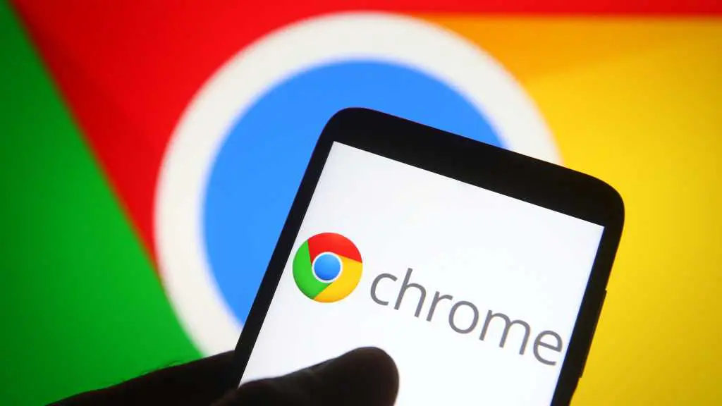Chrome logo on phone in front of larger Chrome display in background