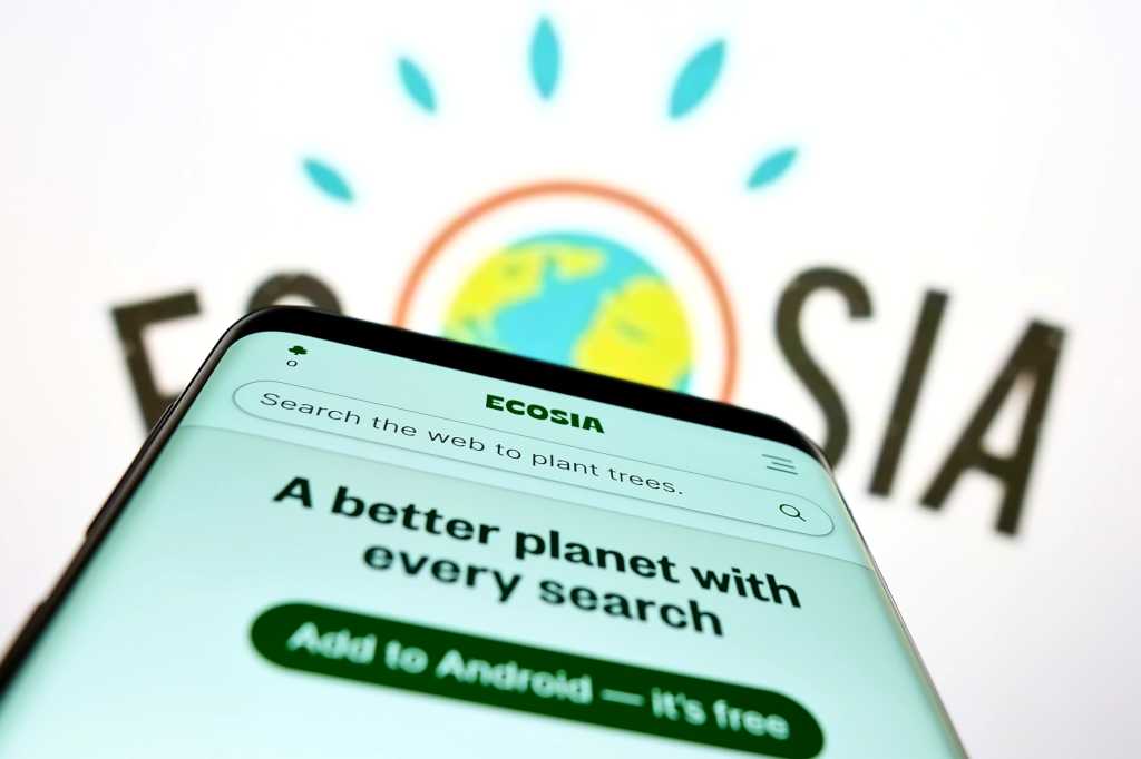 Ecosia search engine on Android phone in front of monitor