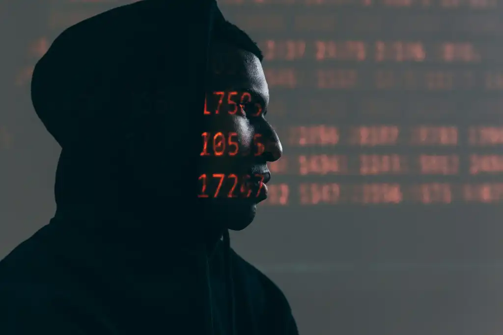 Hacker in a dark room with LED numbers lit on their skin