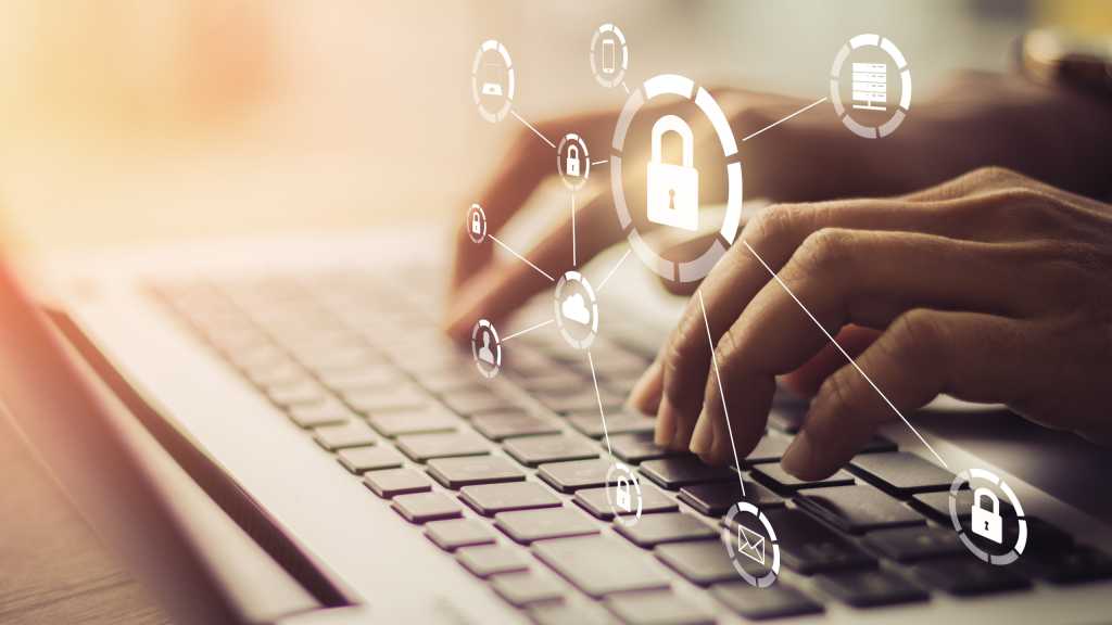 Man on laptop with protective security locking symbols