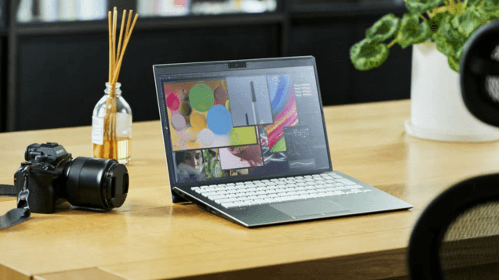 Vaio SX 14 inch laptop promo image. Laptop on a table with a DSLR camera and incense sticks.