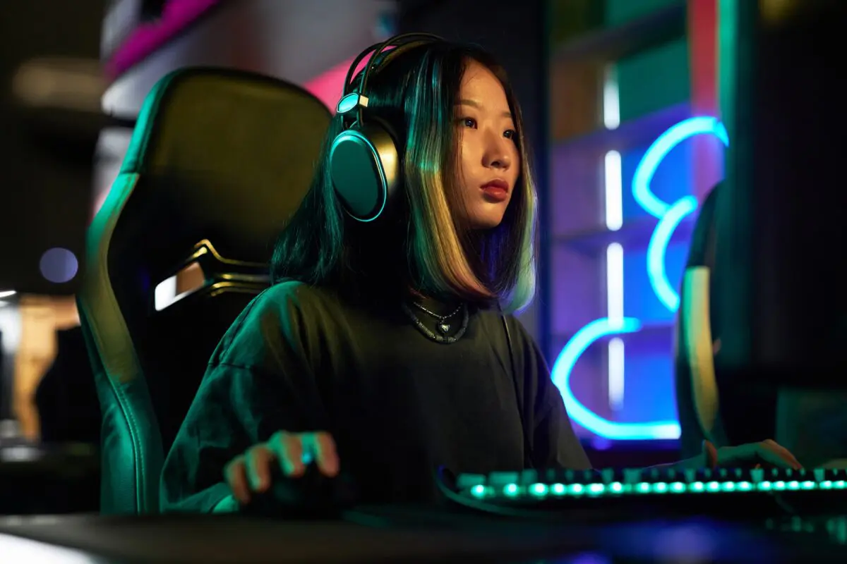 Young Asian Woman Playing Video Games in Neon Lights