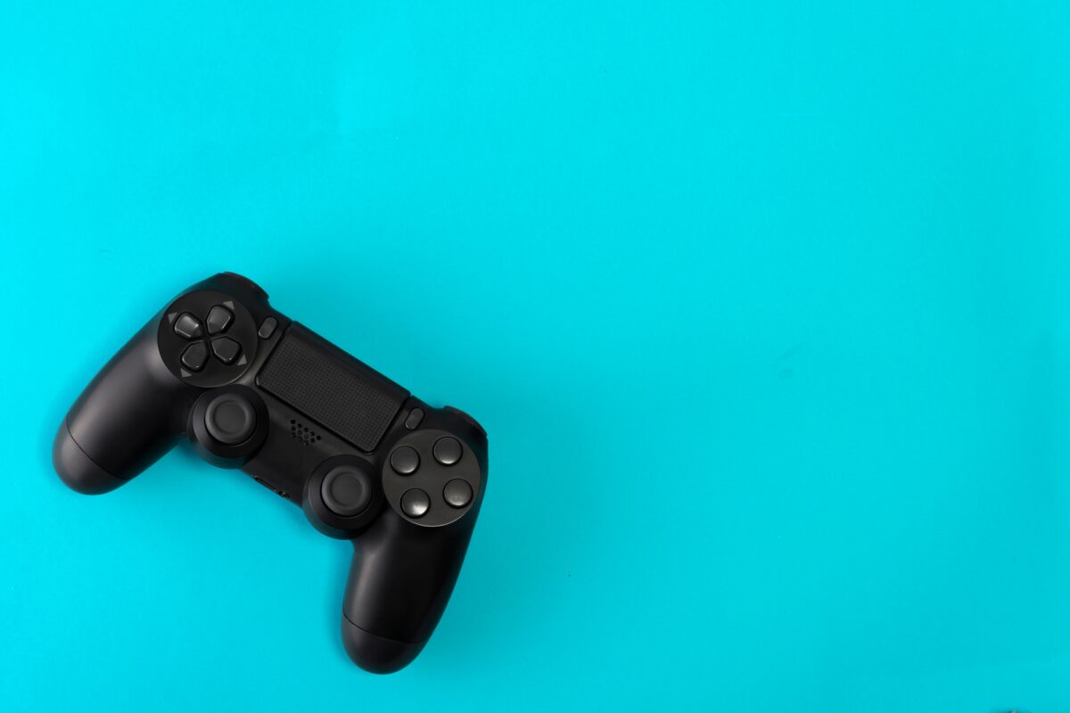 game controller on blue background studio shot