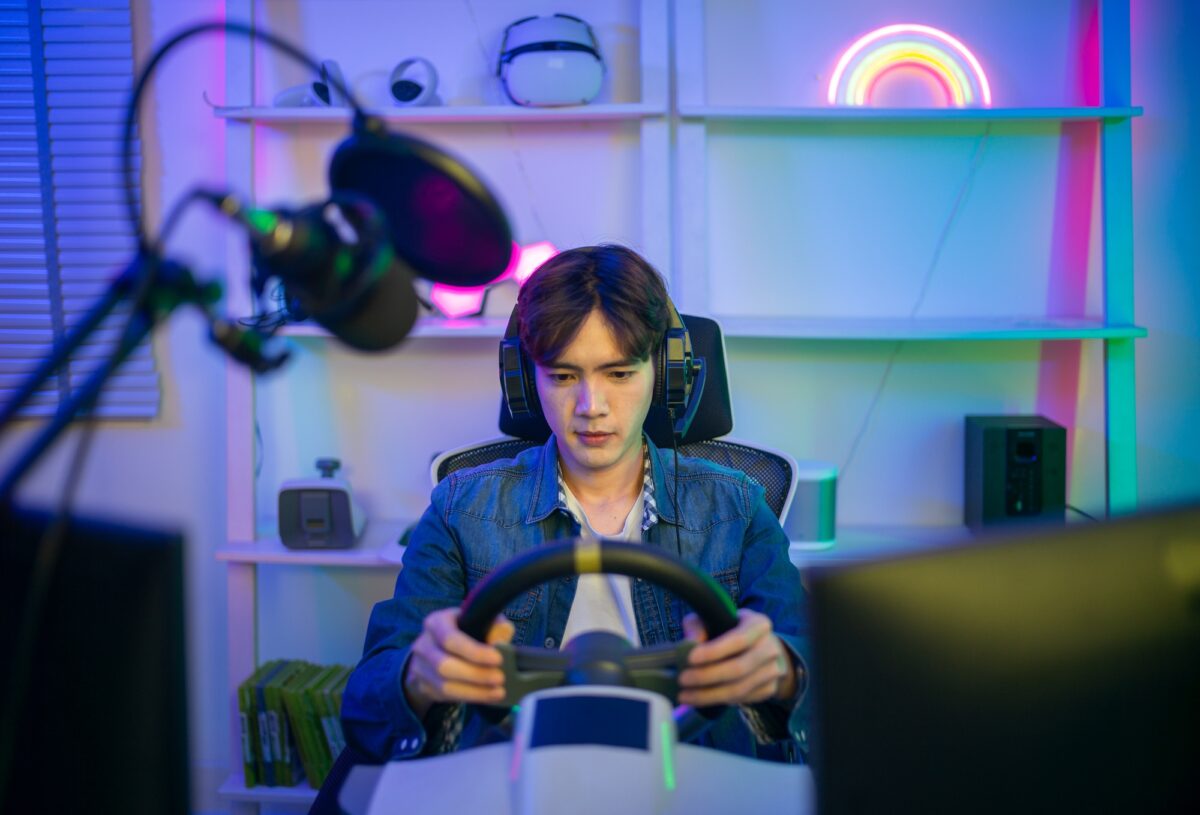 Professional gamer and online streamer in virtual car racing game communicate with his followers